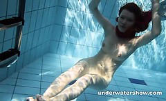 Redheaded Mia stripping underwater